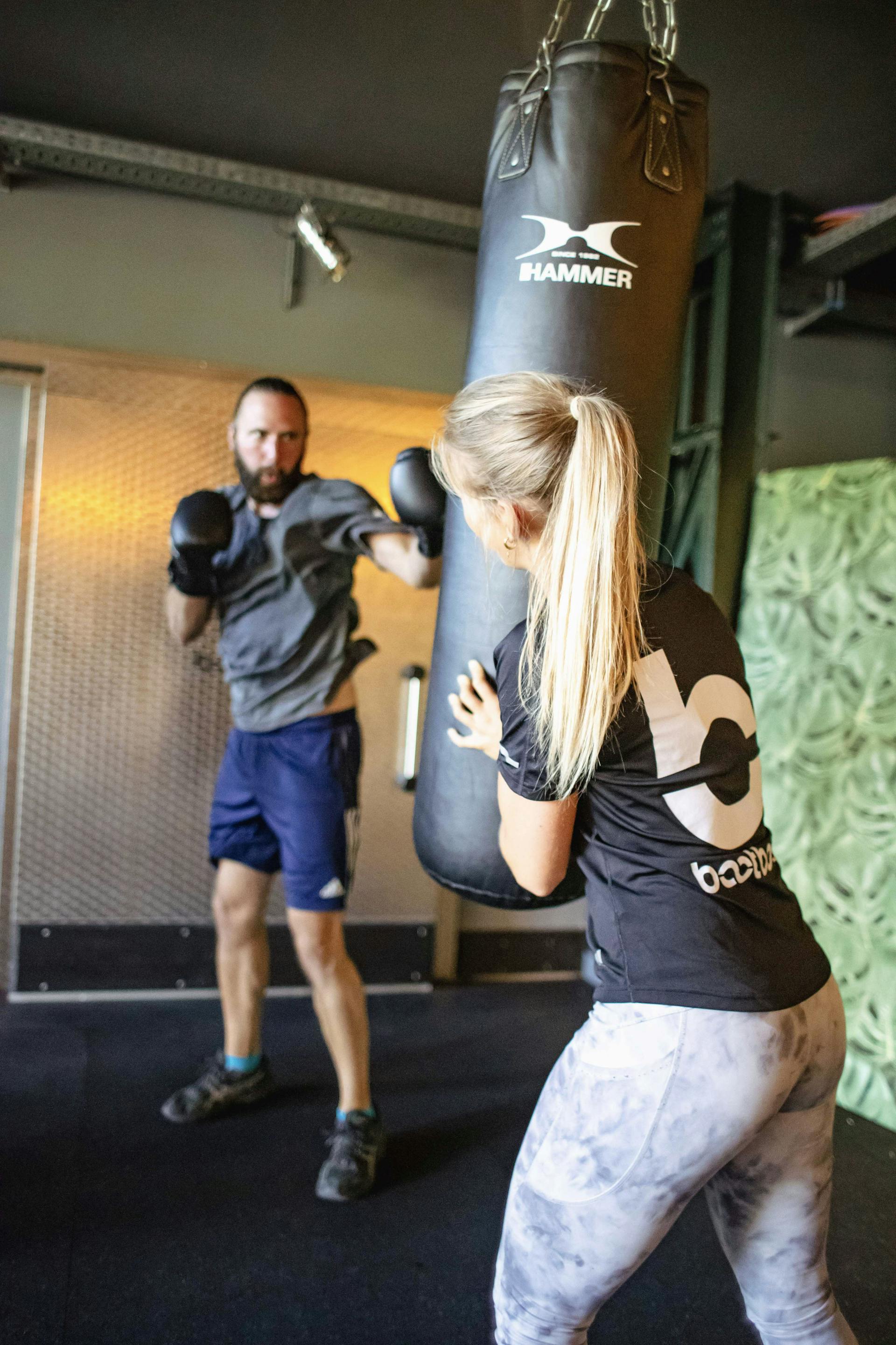 Trainerin Christine Klemm trainiert Kunden am Boxsack.